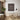 Dining room with a round table and chairs, a plant, and a framed more espresso less depresso quote on the wall.