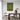 Dining room with a wooden table and chairs, a green framed more espresso less depresso poster on the wall, and a plant.