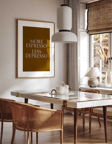Dining room with marble table, wicker chairs, and framed more espresso less depresso quote on wall.