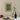 Framed artwork with 'This is our happy place' text above a table setting with wine and cake.